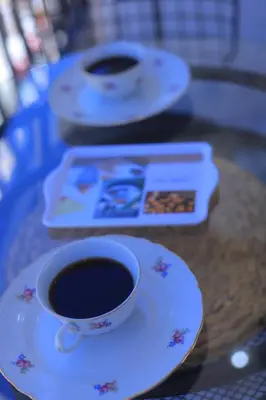 a cup of coffee sitting on a table with a plate at Charmant studio au cœur de Maarif - Confort balcon et emplacement idéal in Casablanca