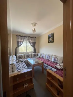 a living room with a couch and a table at Appartement Skhirat , vue sur mer in Skhirat