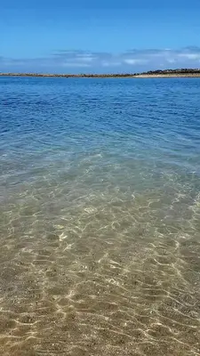 a large body of water with a rocky beach at Appartement Skhirat , vue sur mer in Skhirat