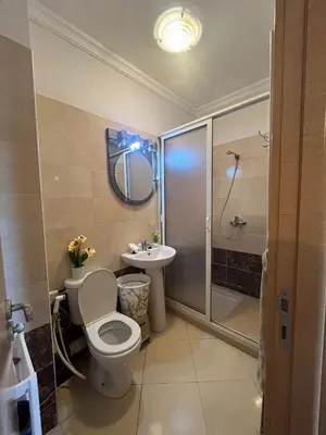 a bathroom with a toilet and a sink and a shower at Appartement Skhirat , vue sur mer in Skhirat