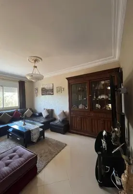 a living room with a couch and a table at Appartement Skhirat , vue sur mer in Skhirat