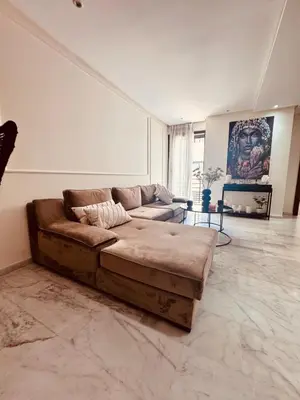 a living room with a brown couch in a room at Central Maarif Studio in Casablanca