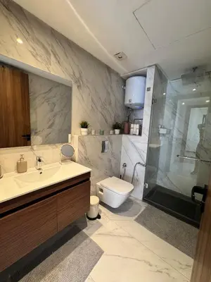 a bathroom with a sink and a toilet and a shower at Central Maarif Studio in Casablanca