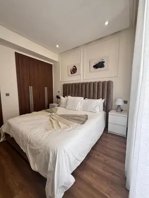 a bedroom with a large bed with white sheets at Central Maarif Studio in Casablanca