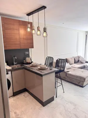 a kitchen and a living room with a couch at Central Maarif Studio in Casablanca