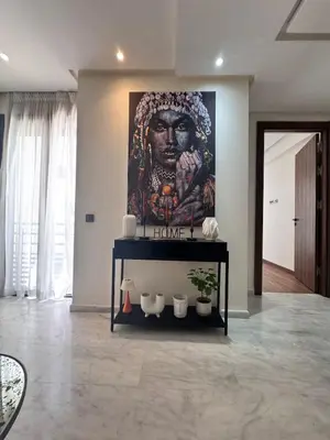 a large painting of a man on a wall in a room at Central Maarif Studio in Casablanca
