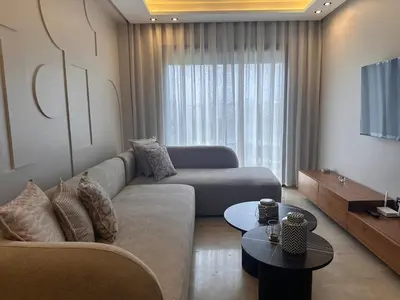 a living room with a couch and a tv at Chic & central in Maarif