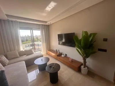 a living room with a couch and a flat screen tv at Chic & central in Maarif
