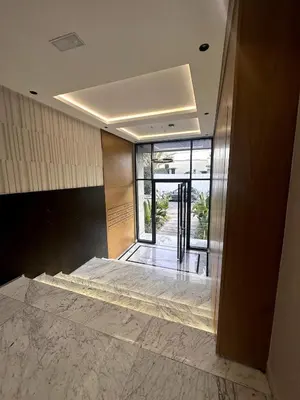 a lobby with a large marble floor and glass doors at Comfortable & Central Casablanca Apartment in Casablanca