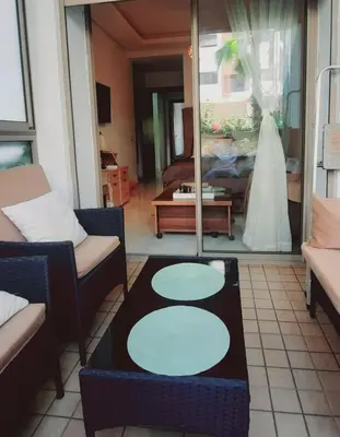 a bride is walking into a living room at Appartement vue piscine à 3min de la plage bouznika in Bouznika