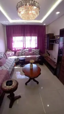 a living room with a couch and a table at Les jardins d'Atlantis Dar Bouazza in Tamaris