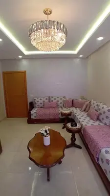 a living room with a couch and a table at Les jardins d'Atlantis Dar Bouazza in Tamaris