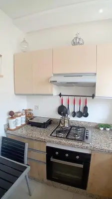 a kitchen with a stove and a counter top at Les jardins d'Atlantis Dar Bouazza in Tamaris