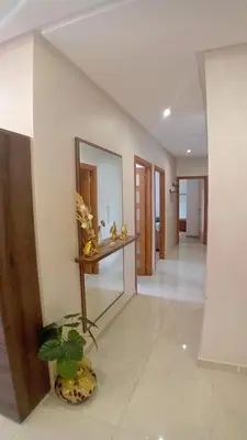 a hallway with a mirror and a plant in a room at Les jardins d'Atlantis Dar Bouazza in Tamaris