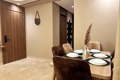 a dining room with a table and some chairs at Évasion luxueuse avec piscine proche de la mer in Mohammedia