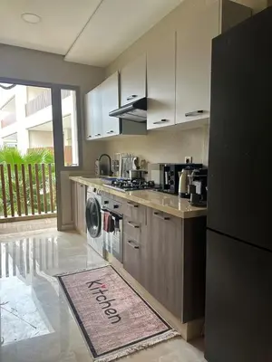 a kitchen with a stove and a refrigerator at Évasion luxueuse avec piscine proche de la mer in Mohammedia