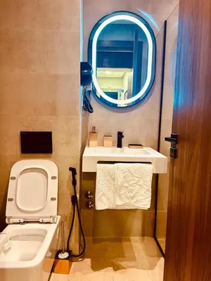 a bathroom with a sink and a toilet and a mirror at Évasion luxueuse avec piscine proche de la mer in Mohammedia