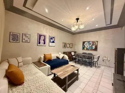 a living room with a couch and a table at Apartment Majorelle Garden in Casablanca