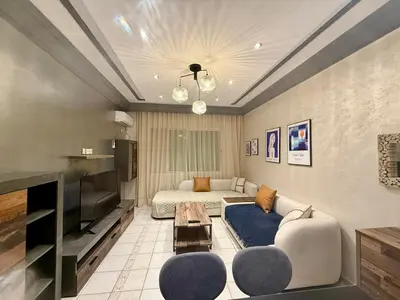 a living room with a couch and a television at Apartment Majorelle Garden in Casablanca