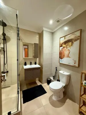 a bathroom with a toilet and a shower and a sink at Apartment Majorelle Garden in Casablanca
