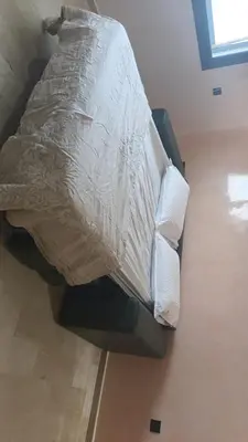 a bed with a white comforter and pillows at Nafhat al arz - Moroccan and refined in Mohammedia