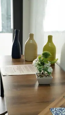 a group of three vases sitting on a wooden table at Nafhat al arz - Moroccan and refined in Mohammedia