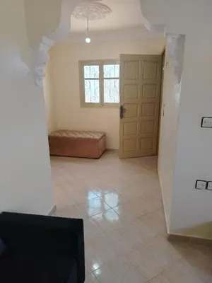 a living room with a door and a window at Dar Isa in Sidi Rahal