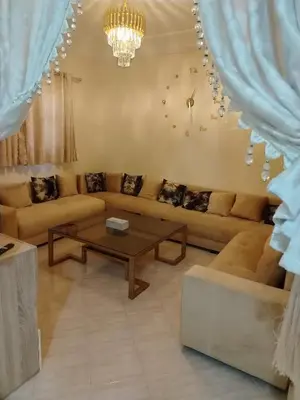 a living room with a couch and a table at Dar Isa in Sidi Rahal