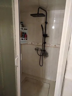 a shower with a shower head in a bathroom at Dar Isa in Sidi Rahal