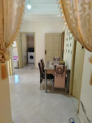 a dining room with a table and chairs at Dar Isa in Sidi Rahal