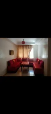 a living room with red couches and a table at إقامة النصر in Casablanca