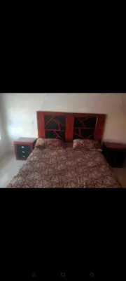 a bed with a wooden head board in a bedroom at إقامة النصر in Casablanca