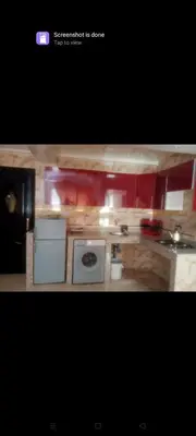 a small kitchen with a stove and a microwave at إقامة النصر in Casablanca