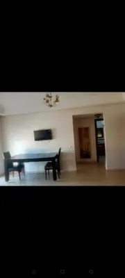 a living room with a table and a bench at إقامة النصر in Casablanca