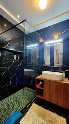 a bathroom with a sink and a glass shower at Studio Cosy les Princesses in Casablanca