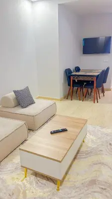 a living room with a couch and a remote control on a table at Living Like Home in Casablanca