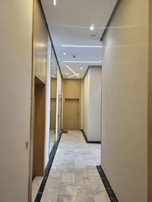 an empty hallway of an office building with a row of doors at Studio Zen vue sur mer in Aïn Harrouda