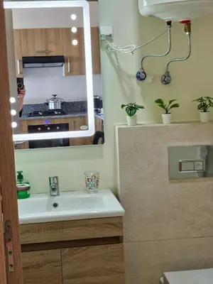a bathroom with a sink and a mirror at Studio Zen vue sur mer in Aïn Harrouda