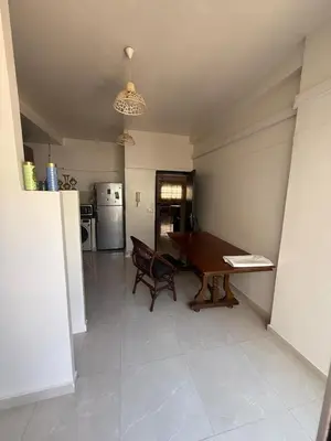 a kitchen with a dining room table and a refrigerator at Appartement central familial avec grande terrasse in Casablanca