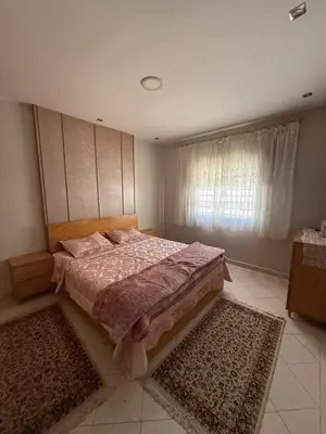 a bedroom with a large bed and a window at Appartement central familial avec grande terrasse in Casablanca
