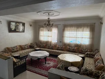 a living room with couches and a chandelier at Appartement central familial avec grande terrasse in Casablanca