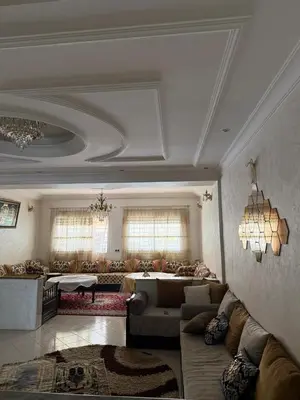 a large living room with a couch and a table at Appartement central familial avec grande terrasse in Casablanca