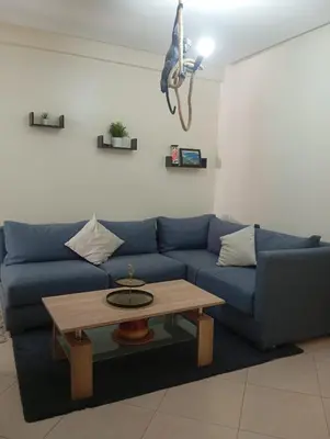 a living room with a blue couch and a coffee table at Elegant apartment in Rabat in Rabat