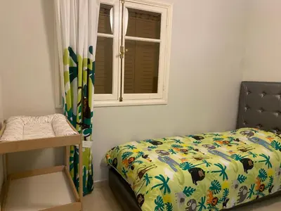 a bedroom with a bed and a window at Appartement location saisonnière Mohammedia in Mohammedia