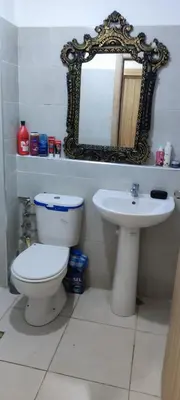 a bathroom with a toilet and a sink and a mirror at Calme absolu in Aïn Harrouda