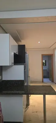 a kitchen with a counter top and a refrigerator at Appartement Flora Nora in Casablanca