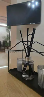a vase with sticks in it on a table at Appartement Flora Nora in Casablanca