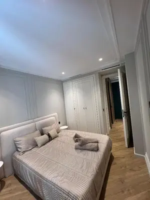 a bedroom with a large bed in a room at Appartement Le Claridge in Casablanca