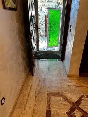 a door with a green window in a hallway at Villa in mohammadia morrocco in Mohammedia