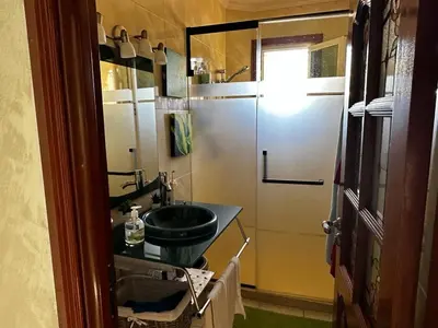 a small bathroom with a sink and a refrigerator at Villa in mohammadia morrocco in Mohammedia
